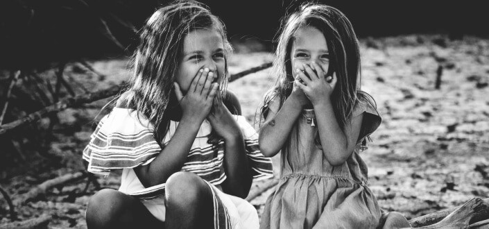 Two cute little girls giggling