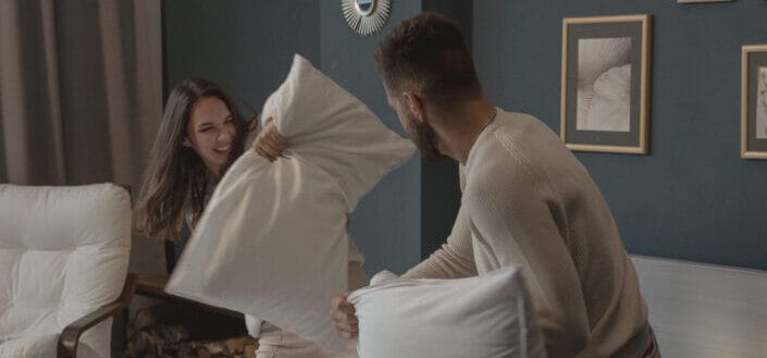 Couple playing a pillow fight
