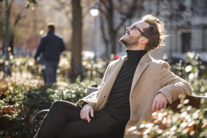 Happy man sitting on a bench