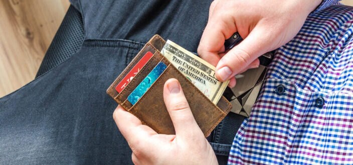 man pulling bills from his wallet