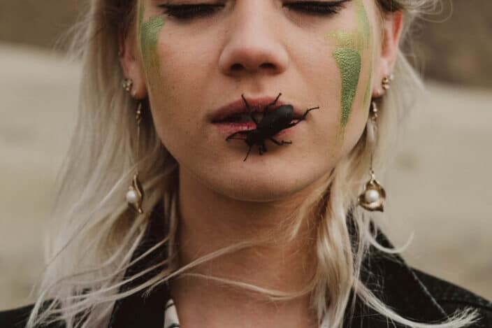 Uncommon photo of a woman with a bug on her mouth