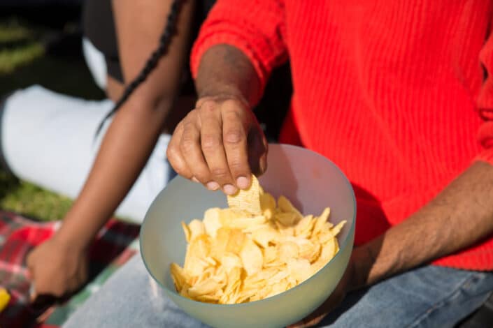 Man taking chips from a bowl