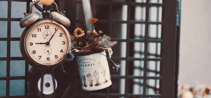 clock and can full of flowers