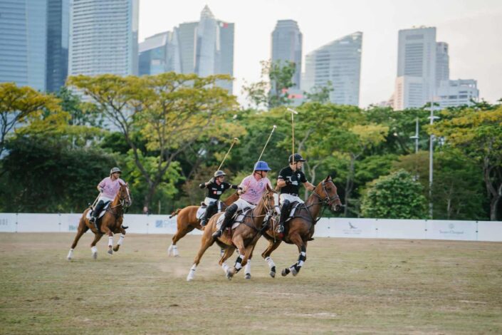 men riding horses about to play polo