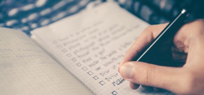 A checklist written on a notebook