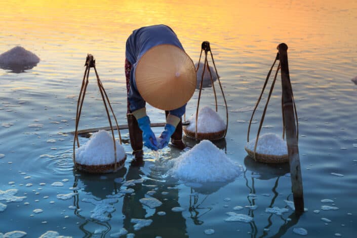 Person collecting salt on body of water