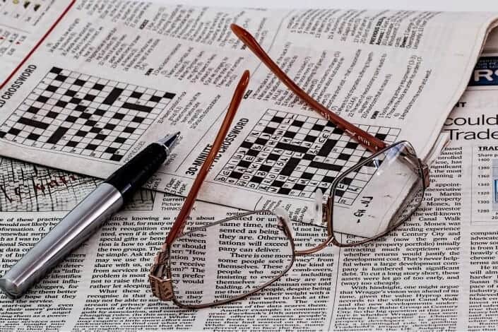 eyeglasses and marker on newspaper