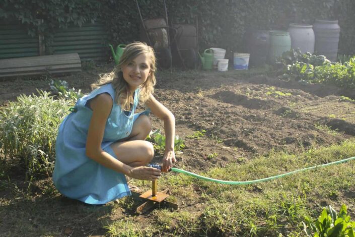 woman holding green garden hose