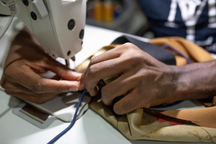 person sewing using machine