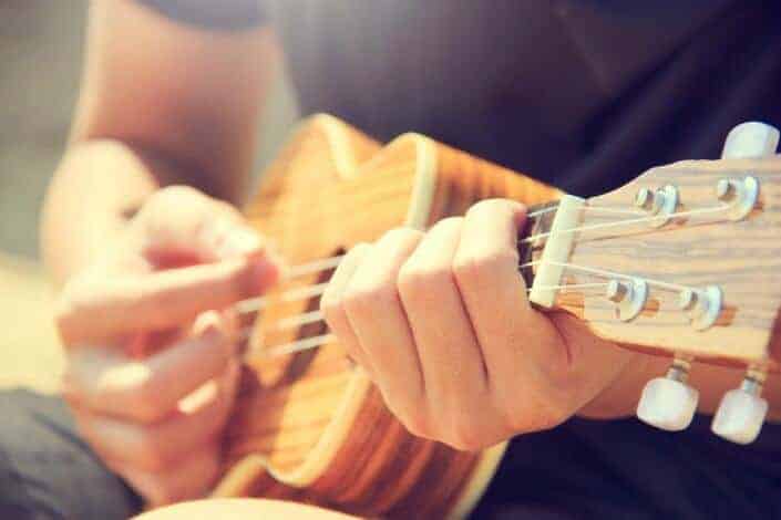 Person strumming his ukulele