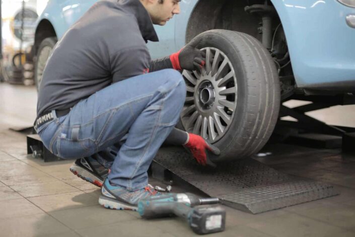 Man fixing the tire of the car