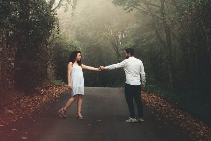 man-and-woman-standing-on-road-near-trees-stockpack-pexels