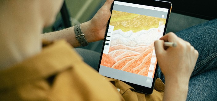 man drawing an art on his tablet