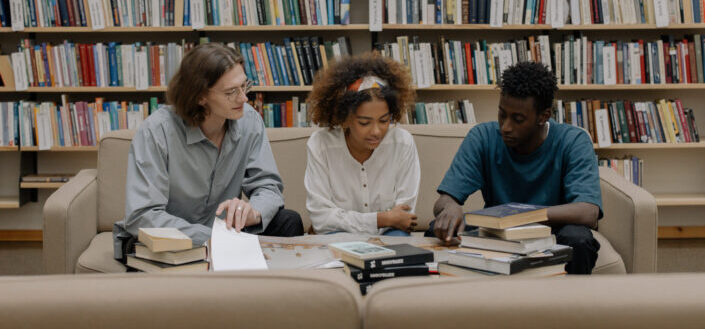 young people researching in a library