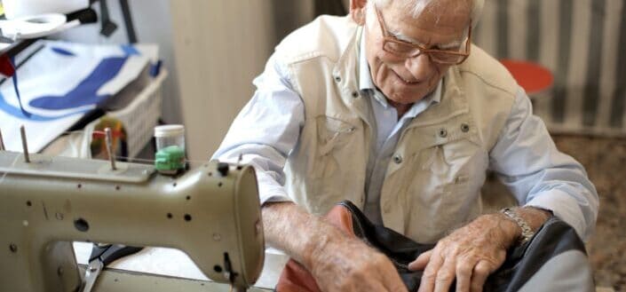 Photo of man sewing