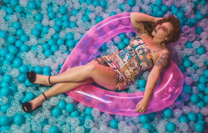 Woman lying on a pit of airballs