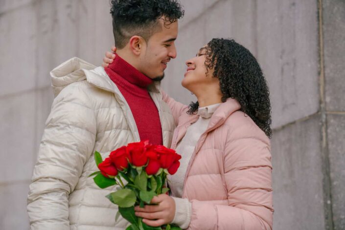 Smiling Couple With Roses Hugging Each Other
