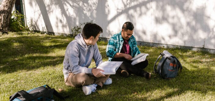 Men studying outdoors.
