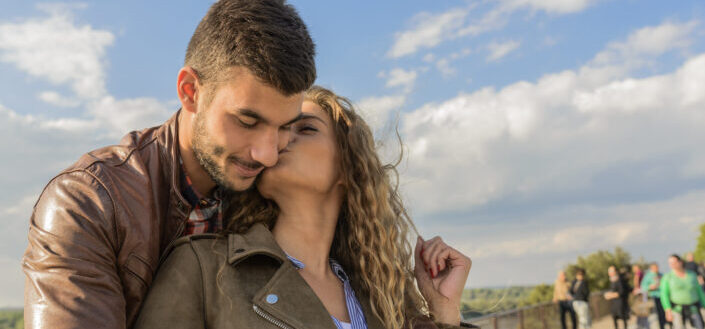 Woman kissing her guy on the cheek